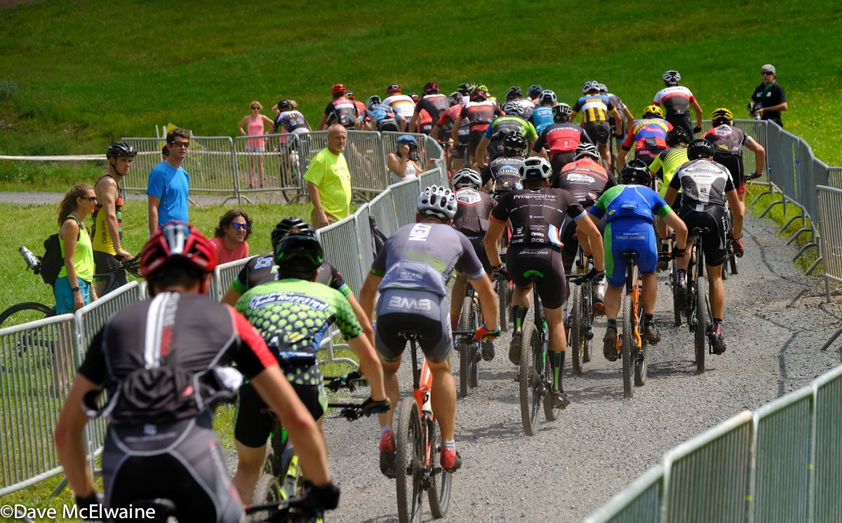 Riders head up a gravel path onto the course