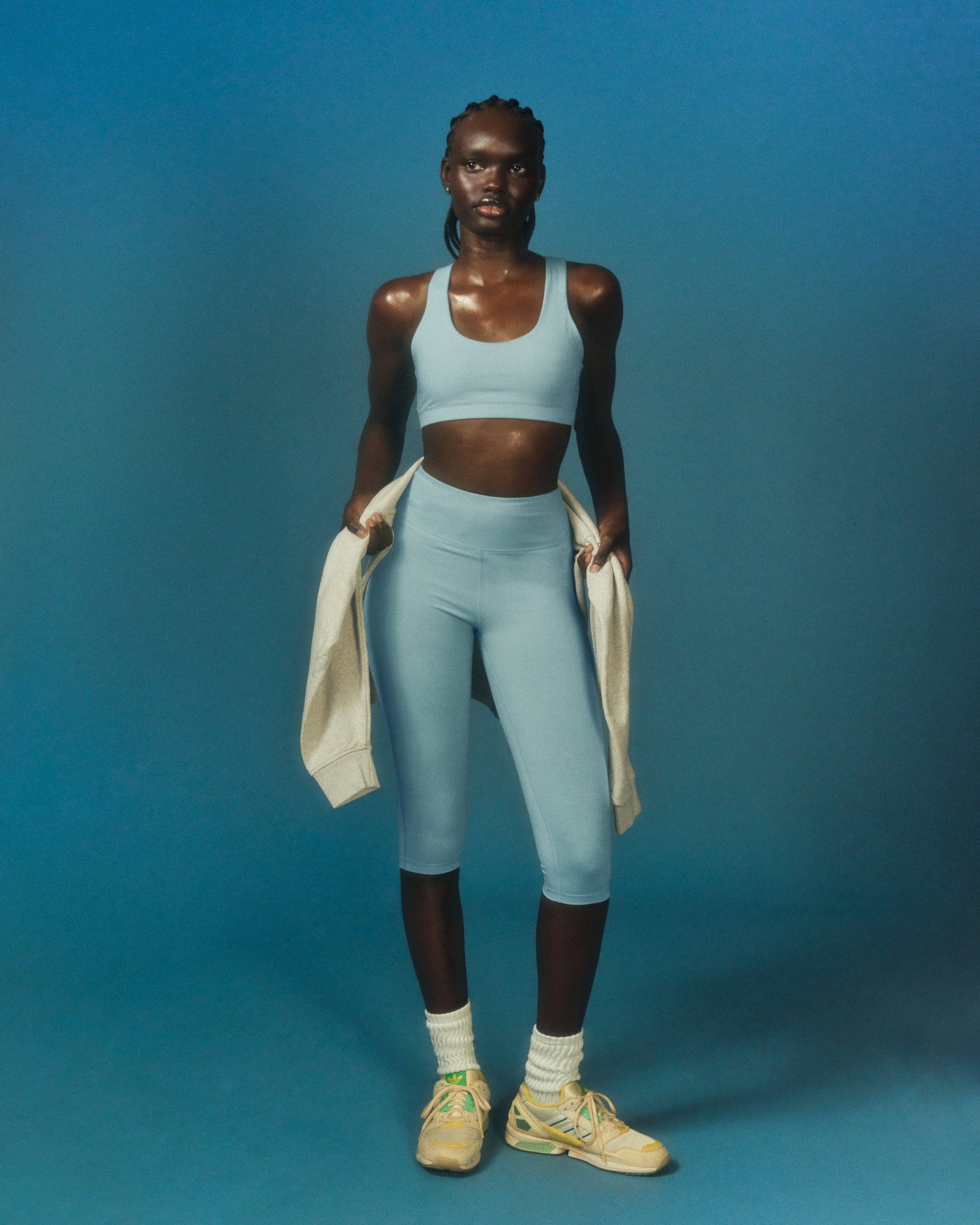 A woman wearing blue sportswear with label companion.