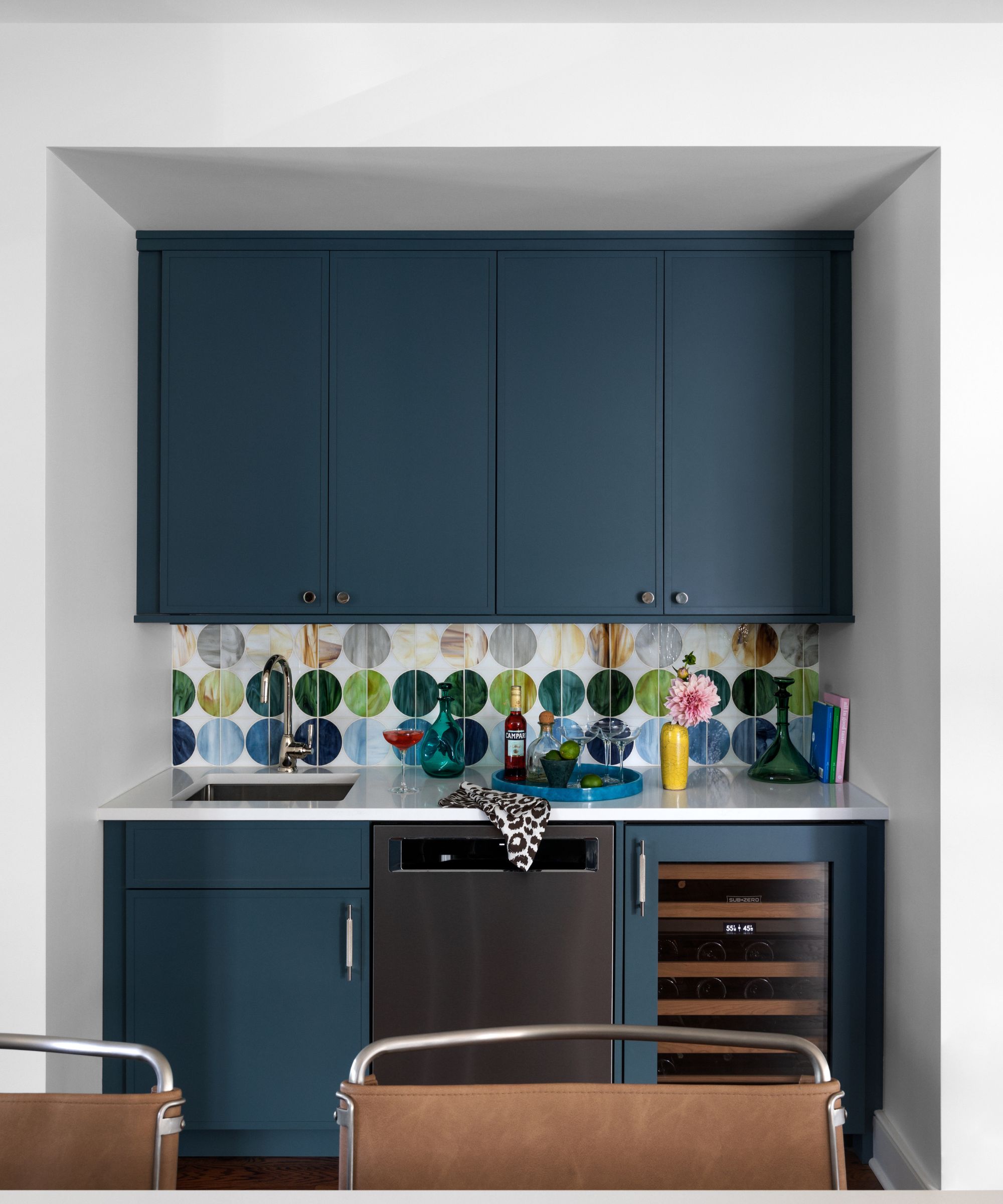 Blue home bar with colorful circular tiles and built in wine fridge