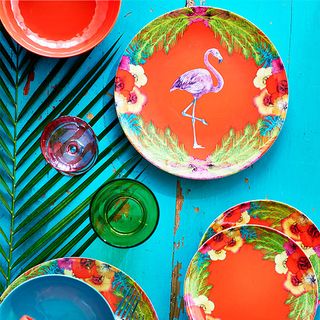 blue table with floral and flamingo print dishes