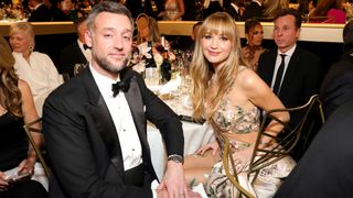 Jennifer Lawrence and Cooke Maroney in formalwear at awards dinner table 2026.