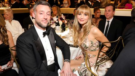 Jennifer Lawrence and Cooke Maroney in formalwear at awards dinner table 2026.