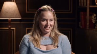 Annabel smiling in a confessional for The Traitors Australia