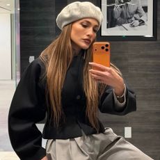 jennifer lopez returned to her L.A. office in a gray beret and matching pleated pants