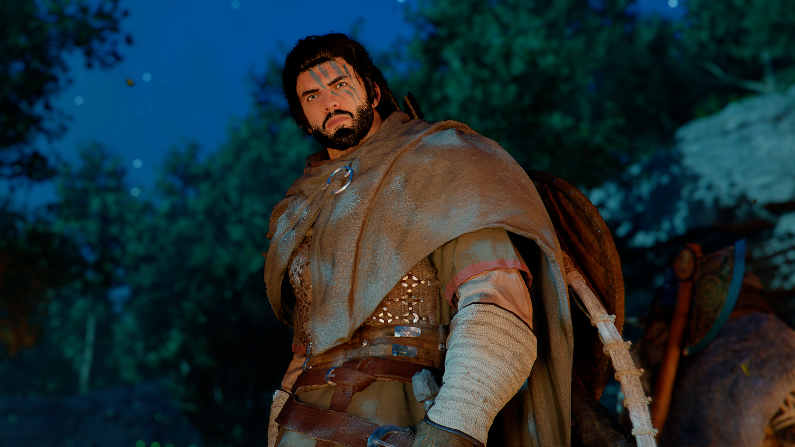 Crimson Desert guide: A low-angled shot of Kliff looking off to the distance, lit by a campfire out of frame.