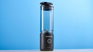 Nutribullet Flex blender photographed on a blue background