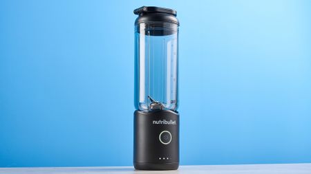 Nutribullet Flex blender photographed on a blue background