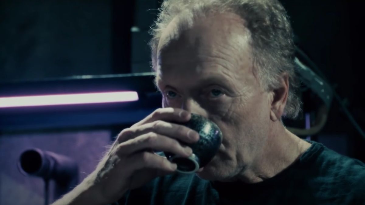 John Kramer sipping a drink