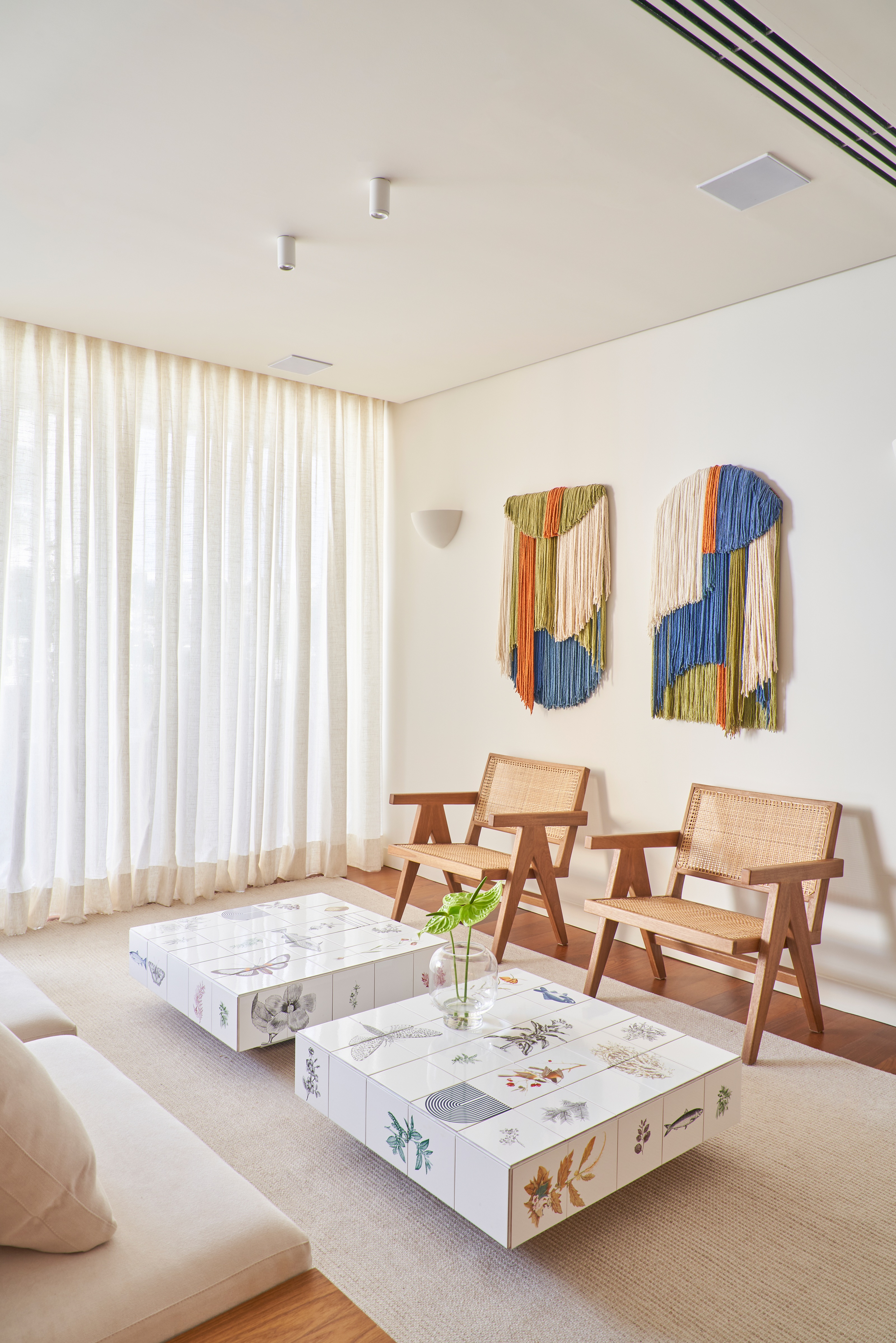 a white room with a coffee table tiled with different plant and animal motifs