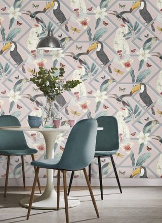 dining room with blue velvet chairs and botanical geometric wallpaper with birds