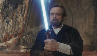 Star Wars: The Last Jedi Luke holds his lightsaber up, ready for battle on Crait