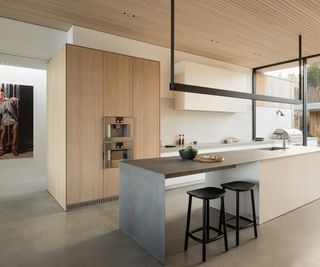 modern wood kitchen with concrete floor and concrete kitchen island