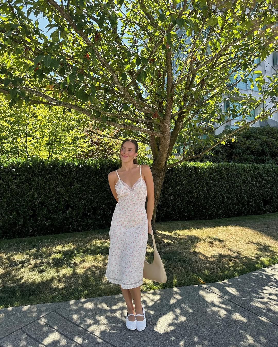 woman wearing floral midi dress and ballet flats