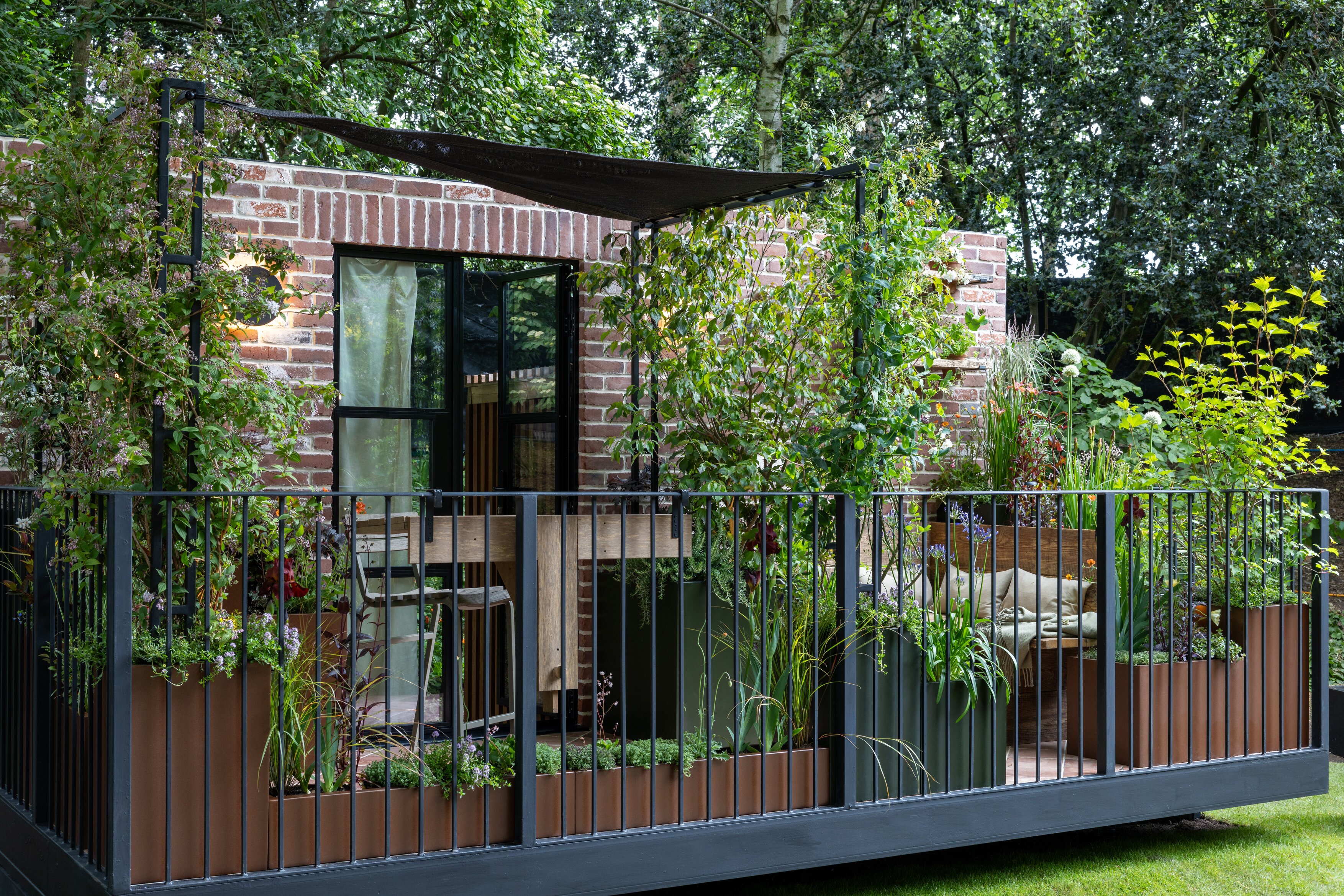 Images and details showing the planting and structure of the transient garden. Lots of brick, leafy greens and brushed metal