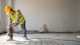 building digging up concrete floor
