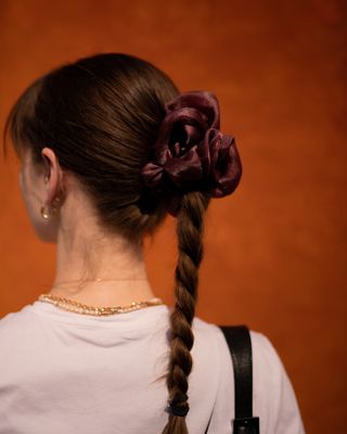 editor Halie Lesavage at Copenhagen fashion week with a pico store scrunchie in her braid