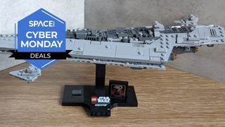 A Lego Super Star Destroyer on a table, on a black stand.