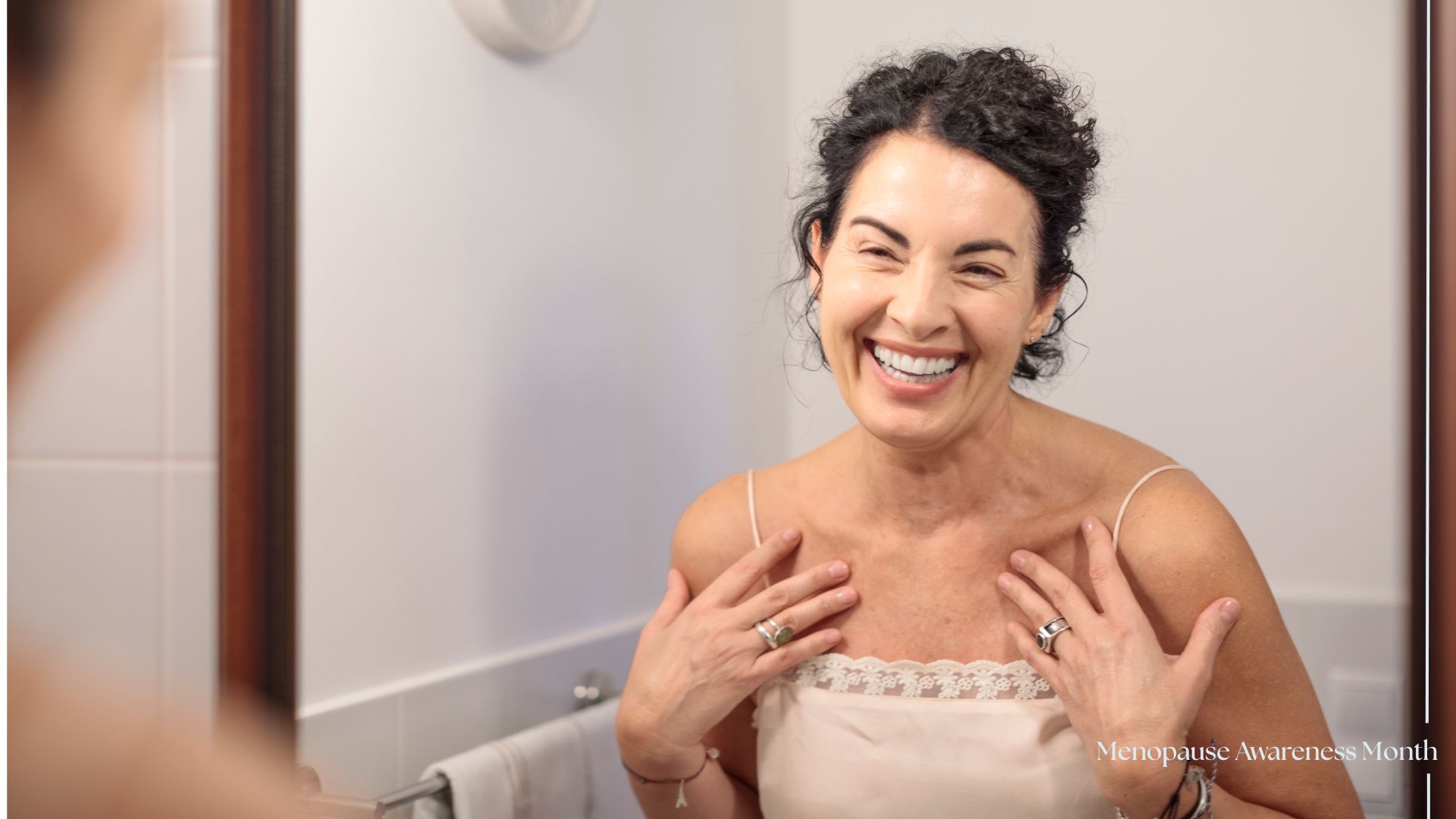 Woman smiling and looking in the mirror, representing alternatives to HRT