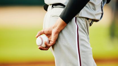 Close up shot of pitcher holding baseball before pitching during game