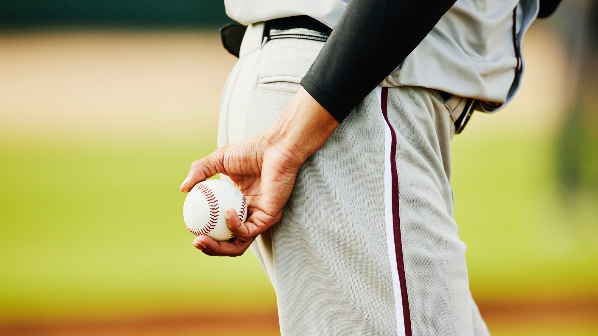 Close up shot of pitcher holding baseball before pitching during game