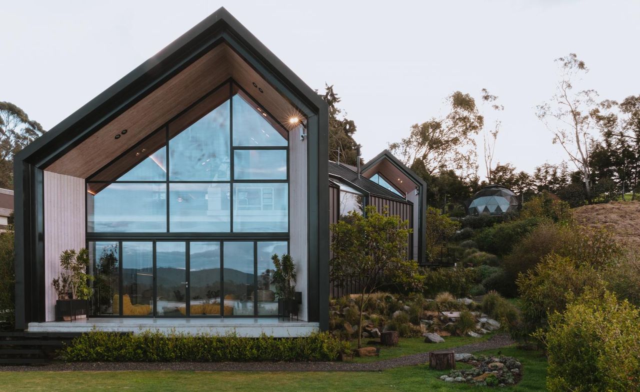 casa sel features black angular volumes within lush greenery