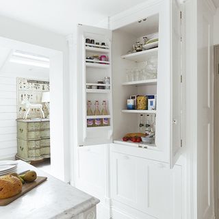 kitchen with white wall and storage shelves