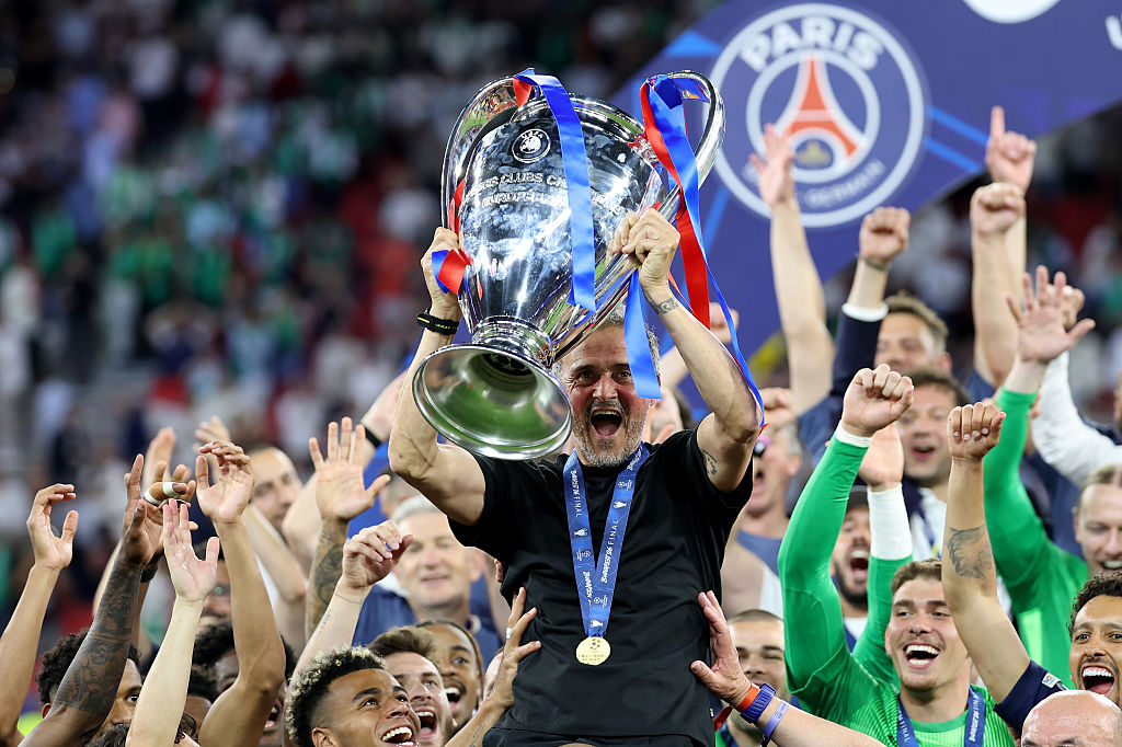 PSG boss Luis Enrique holds the Champions League trophy aloft