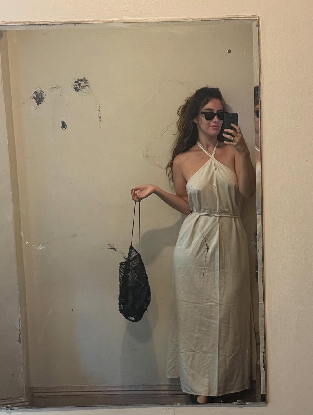 Talia Mayden wearing Baserange dress and Ray-Ban sunglasses.