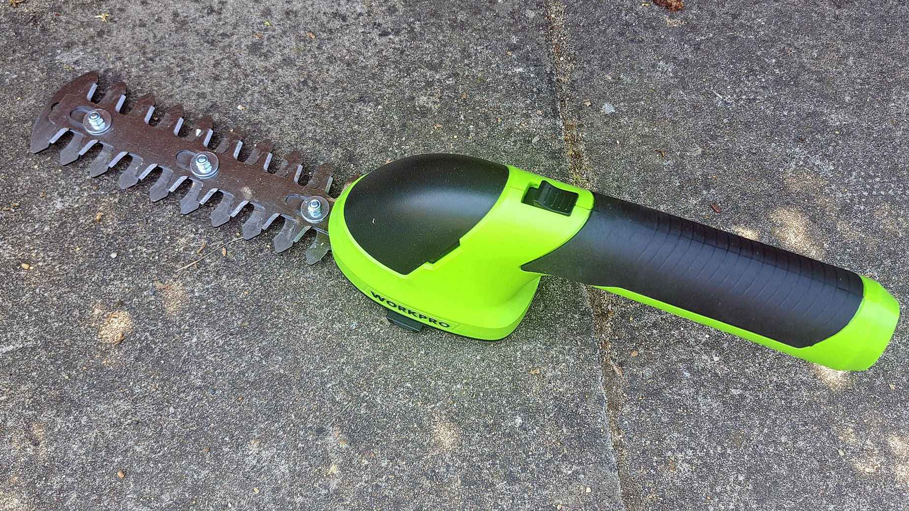 WORKPRO Cordless Grass Shear & Shrubbery Trimmer on patio ground