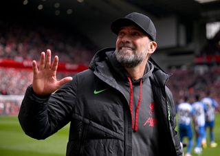 Liverpool manager Jurgen Klopp waves to the fans ahead of a Premier League match against Brighton in March 2024.