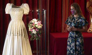 Princess Beatrice admires her wedding dress on display at a Windsor Castle exhibition