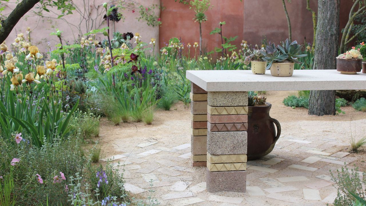 Close up of the plants and stoneware table in RHS Chelsea&#039;s The Mediterranean Garden 