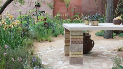 Close up of the plants and stoneware table in RHS Chelsea's The Mediterranean Garden 