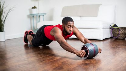 Perfect Fitness Ab Carver Pro review: Pictured here, a person using the home gym equipment in a living room