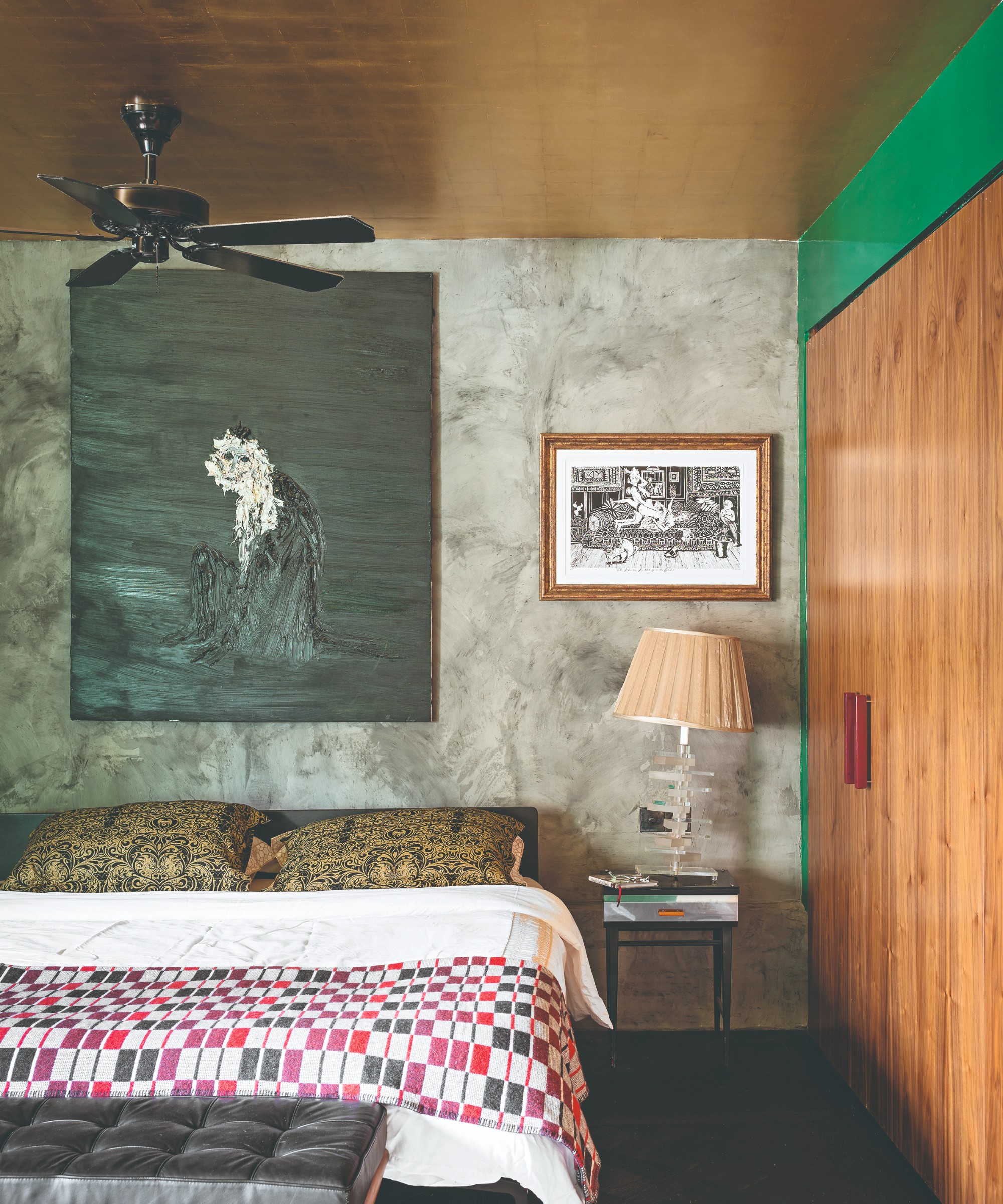 A bedroom with the ceiling covered in a gold metallic wallpaper