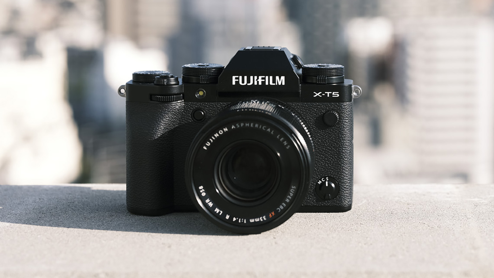 The Fujifilm X-T5 camera leaning against a wall