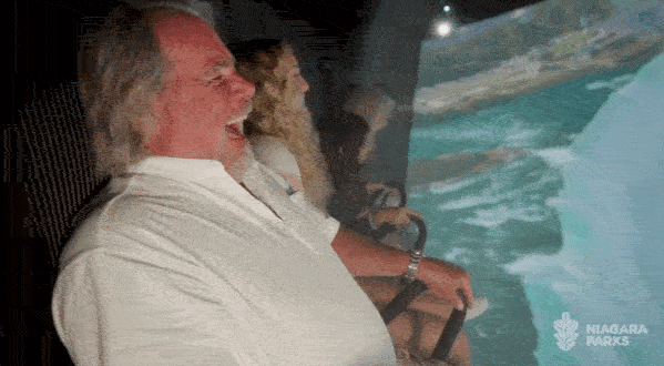 People are all smiles "flying" over Niagara Falls in a new immersive experience.