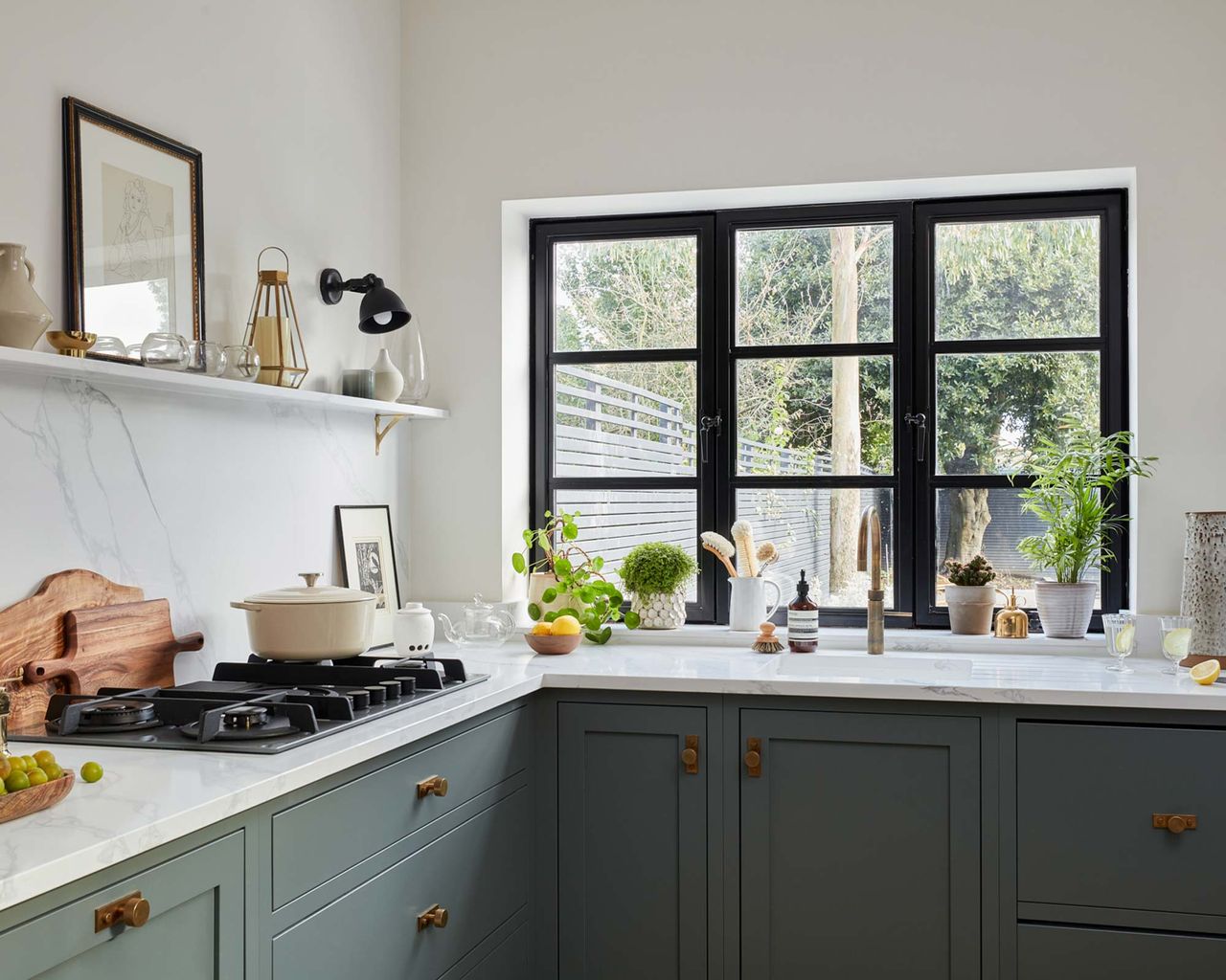 Modern blue kitchen with black framed window and island