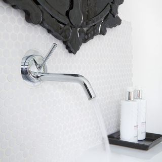 tap on white wall anf mirror