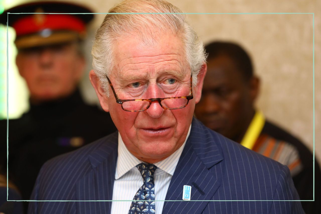 A close up of King Charles wearing reading glasses