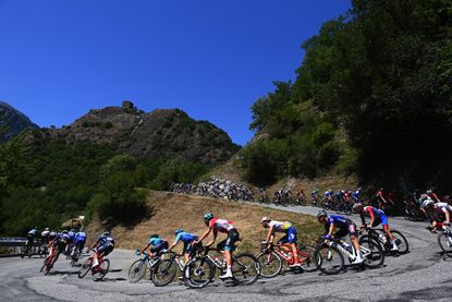 Tour de France peloton descending a hairpin