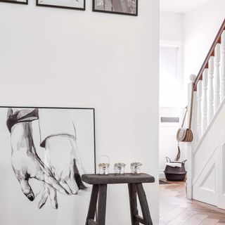 hallway with white walls and wall art on it