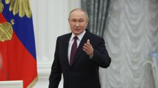 Russian President Vladimir Putin walks through a hall in the Kremlin on May 22, 2025.