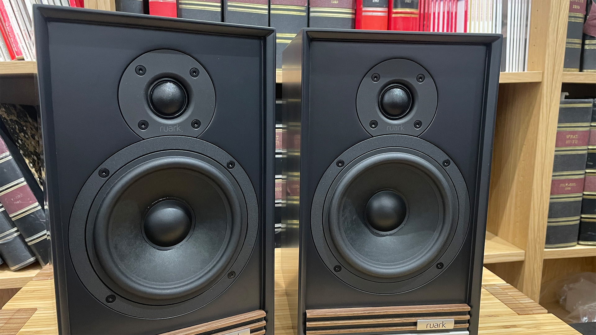 Ruark Audio Sabre-R speakers in black finish on wooden rack