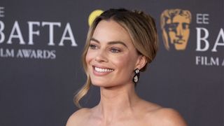 Margot Robbie pictured with a wavy bun at the the 2024 EE BAFTA Film Awards at The Royal Festival Hall on February 18, 2024 in London, England.