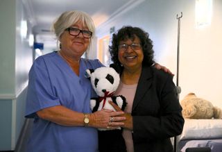 Restored Teddy pictured with Dr Jax and smiling Norma.