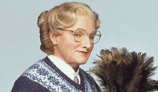 Mrs. Doubtfire Robin Williams with a feather duster, dressed as Mrs. Doubtfire