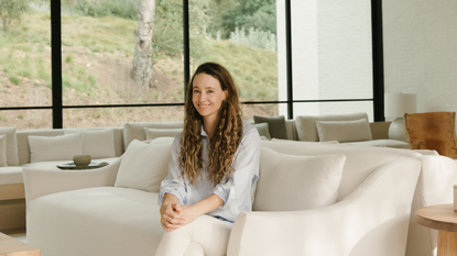 A portrait of Jenni Kayne surrounded by her own home goods products.