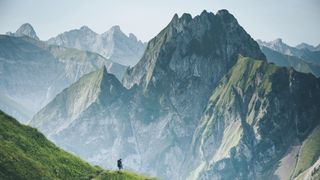 solo backpacking: hiker dwarfed by mountains