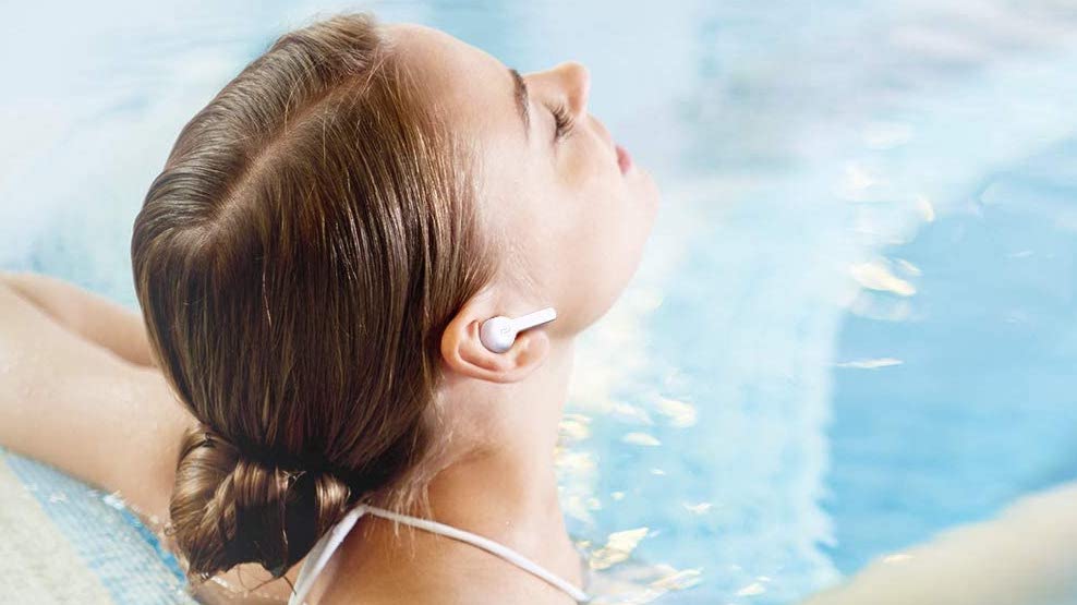 A woman wearing the TaoTronics SoundLiberty 53 in the pool